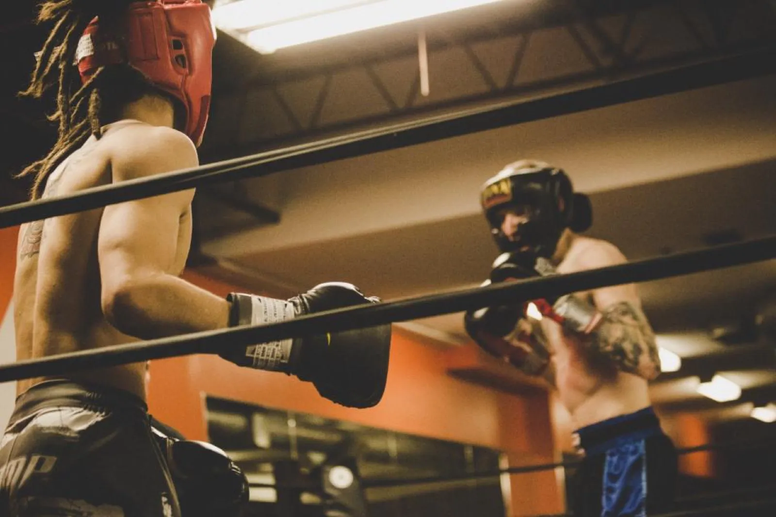 Two boxers sparring in headgear
